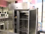 a large stainless steel refrigerator in a commercial kitchen