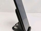 a cell phone that is on a stand on the table