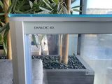 a glass display case with a cell phone inside of it
