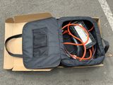 an open suitcase with wires in it sitting on the ground
