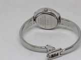 a silver ring with a silver watch on top of it