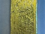 two gold bars sitting side by side on a blue surface