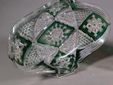 a green and white glass bowl on a white table