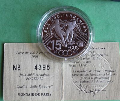 a silver coin sitting on top of a piece of paper