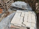 a pile of bricks sitting on the ground next to a fence