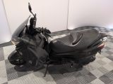 a motor scooter that is sitting on a checkered floor