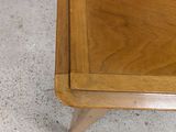 a wooden table with a drawer on top of it