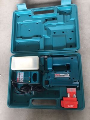 a blue tool box with tools inside of it on the floor