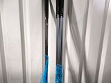 pair of black and blue skis sitting on top of a white table