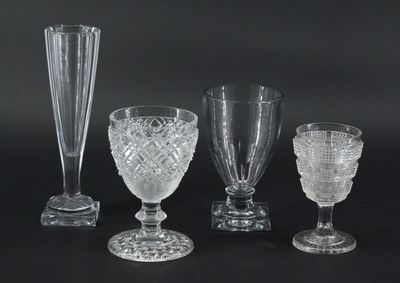 quatre vases en verre et un verre à vin sur fond noir