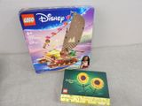 a box of legos with a picture of a boat and sunflowers on it