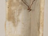 a wooden shelf with a rope hanging from it ' s side