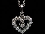 a close up of a heart shaped pendant on a chain