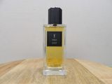 the bottle of the perfume is sitting on a wooden table