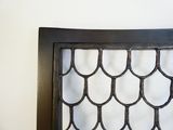 a picture of a decorative iron headboard made of wood