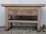 a wooden table with two drawers on top of it