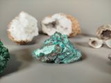 several pieces of green and white rocks on a gray surface