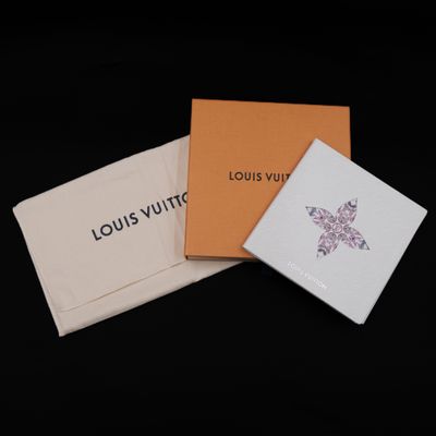 three louis vuitto cards in a box on a black background