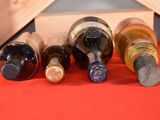 several bottles of wine are lined up in a row on a table