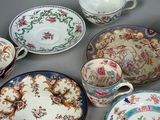 many different types of plates and bowls on the table