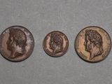 three different types of coins are shown on a gray surface
