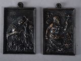 pair of antique black and gold metal wall plaques of a woman and a man