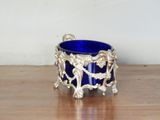 a blue glass bowl sitting on a wooden table
