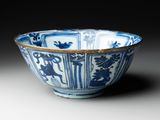 blue and white bowl with birds and flowers on it