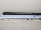 a close up of a fishing rod on a table next to a bag