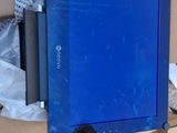 a blue laptop sitting on top of a cardboard box