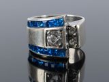 a close up of a silver ring with blue and white stones