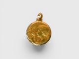 a gold coin with a woman ' s face on it