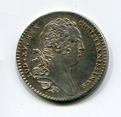 a silver coin with a portrait of a man on it