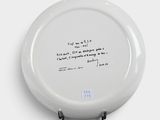 a white plate with a black writing on it