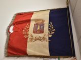 a large flag hanging on the wall in a room