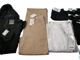 several pairs of men ' s pants and shirts laid out on a white surface