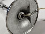 a metal object with a wire attached to it on a table