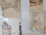 a bunch of drawings hanging on the wall of a room