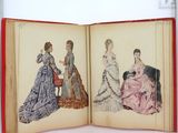 an open book with a picture of women in dresses on it