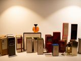 many different types of perfumes on display on a table