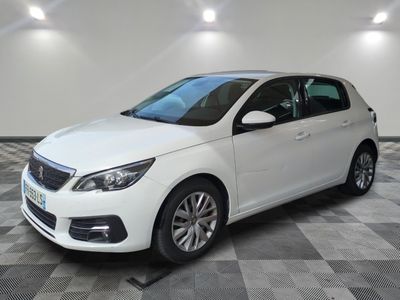 the white car is parked in the garage on a checkered floor