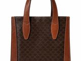 a brown and black handbag on a white background
