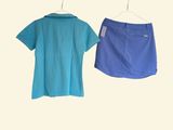 two shirts and a skirt hanging on a clothes hanger