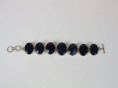 a close up of a row of blue glass beads on a silver chain