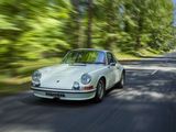 a white car that is driving down the road