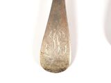 a spoon and a spoon rest on a white surface