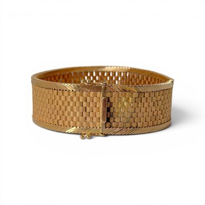 an image of a gold bracelet on a white background