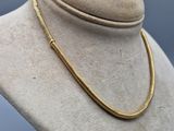 a close up of a mannequin with a necklace on it