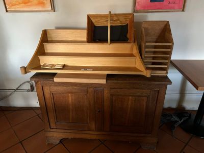 a wooden desk with a drawer on top of it