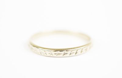a close up of a white gold ring on a white background